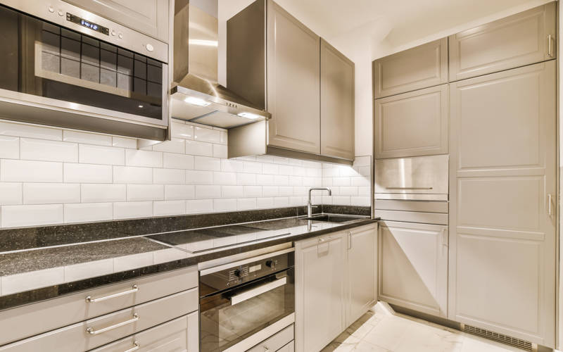 Kitchen in a new luxury home, hardwood floors, dark cabinets